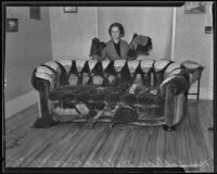 Lillian Mildred Rice stands behind her destroyed sofa, Los Angeles, 1935
