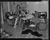 Lillian Mildred Rice in the midst of some of the ruined furnishings of her home, Los Angeles, 1935