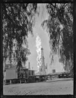 Oil well fire erupts in middle of oil field, Santa Fe Springs, 1935
