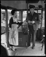 Passenger Esther Pearce pays fare to trolley operator J.W. Looney, Los Angeles, 1935