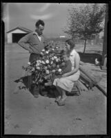 A.G. Busby with wife Bessie Daugherty, young son Eugene, and cotton plants, Fresno, 1935