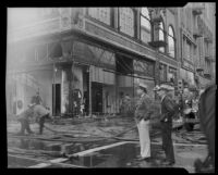 Bystanders look on as crews work on the Norton Building fire aftermath, Los Angeles, 1935