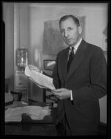 District Attorney Buron Fitts examines perjury papers, Santa Barbara, 1935