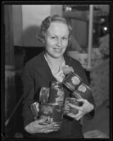 Doris George holds an armful of Del Monte canned products at the Food and Household Show, Los Angeles, 1935