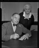 Rose C. Bryant watches as William S. Baird writes check to Friday Club, Los Angeles, 1935