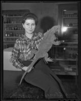 USC student Jane Alvies with an iguana from the Galapagos Islands, Los Angeles, 1935