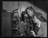 Louise Brant and Ione Hooven operate optical equipment, Los Angeles, 1935