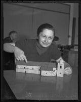 Jayne Hollingsworth sits with an architectural model of a mission, Los Angeles, 1935