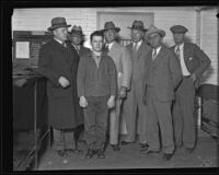 William Edward Hickman, convicted for murder of Marion Parker, poses with officers, Los Angeles, 1928