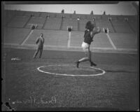 Athlete Bud Houser throwing a discus at the Coliseum, Los Angeles, 1922-1926