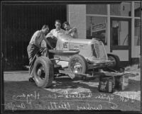 Spider Matlock, Dan Hogan, and Curley Wetteroth work on a race car, Los Angeles, 1935