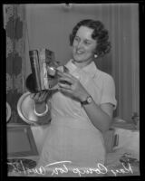 Kay Compton displaying metal bookend at households exhibit, Los Angeles, 1935