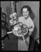 Kay Compton displaying antique cups at households exhibit, Los Angeles, 1935