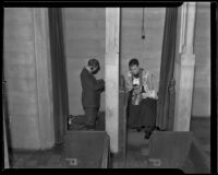 Father George W. Pauch with penitent at confessional, Los Angeles, 1935