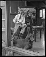 Paul Sample in his studio with his dog, Pasadena, circa 1935