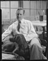 Paul Sample in his studio with his dog, Pasadena, circa 1935