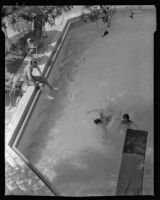 William Conselman watching his children, Deirdre and William, in their swimming pool, Eagle Rock, 1930-1939