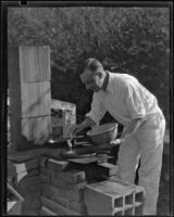 Arthur Millier cooking outdoors, Santa Monica, circa 1930-1931