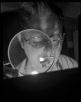 Man looking through a hand lens, 1930-1960