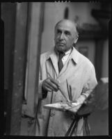 Bert Geer Phillips painting in his studio, Taos, 1932