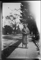 Alice Millard on the sidewalk in front of Olive Percival's house, 1915-1938