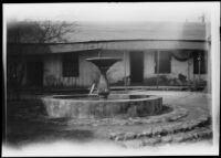 Fountain near old building, possibly in Chinatown, (Los Angeles?), 1900-1930