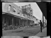 Exterior view of street with Ma Jen Low Cafe in old Chinatown, Los Angeles, 1911