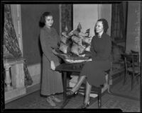 Juniors of Mayflower Descendants, Virginia Davis and Janet Quillian pose next to a replica of the Mayflower, Los Angeles, 1935