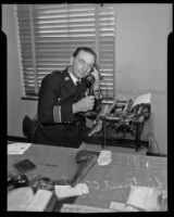 Van Nuys Lieutenant C. C. Johnson, poet laureate of the Los Angeles Police Department, sits at his desk, Los Angeles, 1936