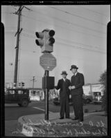 Councilman Lawrence Klinker and Chief of Police Harold Atkinson inspecting the new traffic signal at Slauson and Soto, Huntington Park, 1936