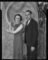 Alice Pheland and B. F. Enyeart pose in front of the Burbank City Schools' Tournament of Roses parade float framework, Pasadena vicinity, about 1936