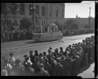 Crowd assembled in front of Los Angeles City Hall for Four Square Church parade admiring a parade float, Los Angeles, 1936