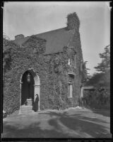 Woman visits a vine-covered mansion, Los Angeles vicinity, about 1936
