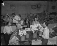 Customers wait to purchase flowers from a grower at the flower market, Los Angeles, 1935