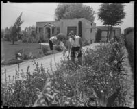 Members of the Wood family pick flowers at their small farm home, San Fernando Valley, 1935