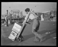 Man moving crates at a produce market, Los Angeles, 1936