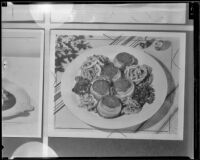 Bacon-wrapped meat patties with fried onions, 1936