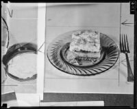Square slice of layer cake on a plate, 1936