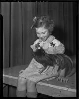 Little girl and a small black chicken, Los Angeles, 1936