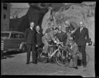 Sheriff Eugene Biscailuz and Bill Jenkins sit atop bicycles and pose with fellow Wheelmen during a meeting, Los Angeles vicinity, 1938
