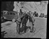 Wheelmen, Bill Jenkins, Tracy Q. Hall and Sheriff Biscailuz pose with a high-wheeler during a meeting, Los Angeles vicinity, 1938