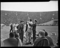 Howard Jones coaches Trojan Al Krueger before he enters the field against Notre Dame, Los Angeles, 1938