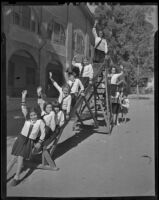 School children go down a slide, Los Angeles, 1938