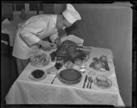 Cook carves a roasted Thanksgiving turkey, [Los Angeles?], 1938