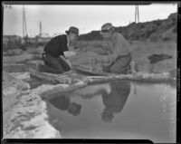 Joe Parra and E. Rea examine a gold nugget, Los Angeles, 1938