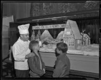 Chef Gus Schaarschmidt showing candy Christmas decorations, Los Angeles, 1938