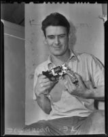 J. E. Moorhouse holding a disassembled revolver, Sierra Madre, 1938