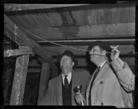 Detective Lieutenants Ray Giese and Dalton R. Patton examine William Spinelli's cellar, Los Angeles, 1938