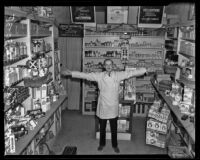 Orville Clark poses in his small drugstore, Los Angeles, 1938