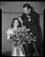 Lathrop K. Leishman places a crown on the head of Tournament of Roses queen Barbara Dougall, Pasadena, 1938